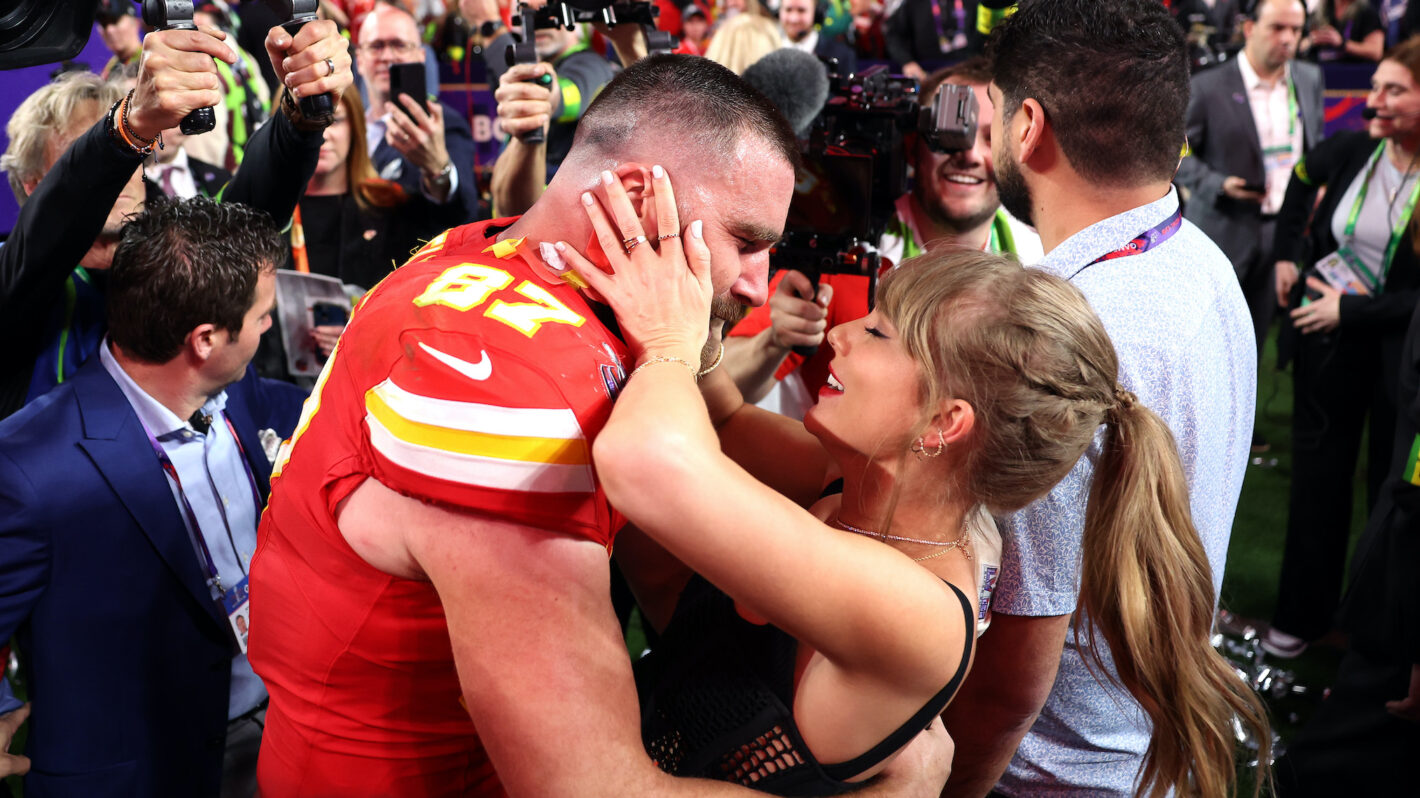 Travis Kelce #87 of the Kansas City Chiefs celebrates with Taylor Swift after defeating the San Francisco 49ers 25-22 in overtime during Super Bowl LVIII at Allegiant Stadium on February 11, 2024 in Las Vegas, Nevada.
